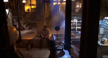 Movie still from “Disturbing Behavior” (1998), directed by David Nutter – A man sitting on a bench in a room; Wide shot, High angle