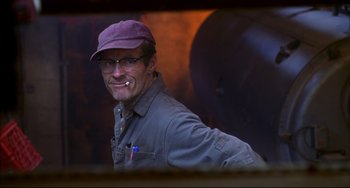 Movie still from “Disturbing Behavior” (1998), directed by David Nutter – A man wearing glasses and a purple hat; Close Up shot, Low angle