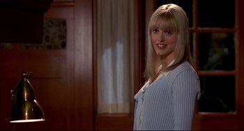 Movie still from “Disturbing Behavior” (1998), directed by David Nutter – A woman with blonde hair standing in front of a door; Medium shot, Over the shoulder angle