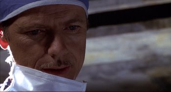 Movie still from “Disturbing Behavior” (1998), directed by David Nutter – A man wearing a surgical mask; Close Up shot, Low angle