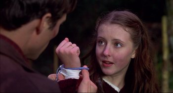 Movie still from “Disturbing Behavior” (1998), directed by David Nutter – A young girl is tying a ribbon around her face; Close Up shot, Over the shoulder angle