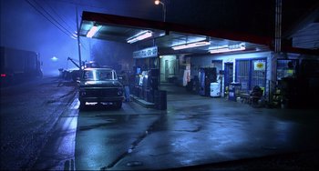 Movie still from “Disturbing Behavior” (1998), directed by David Nutter – A car is parked in a garage at night; Wide shot, High angle