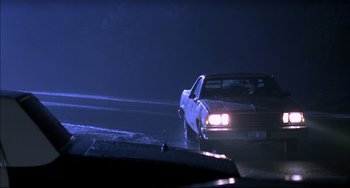 Movie still from “Disturbing Behavior” (1998), directed by David Nutter – A car that has been wrecked in the rain; Wide shot, Low angle