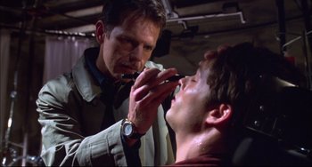 Movie still from “Disturbing Behavior” (1998), directed by David Nutter – A man is brushing his teeth while another man watches; Close Up shot, Low angle