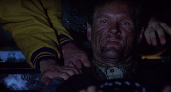 Movie still from “Disturbing Behavior” (1998), directed by David Nutter – An older man sitting in a car with a hand on his shoulder; Close Up shot, Low angle