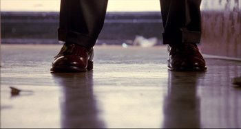 Movie still from “Disturbing Behavior” (1998), directed by David Nutter – View of a man's feet in dress shoes; Extreme Close Up shot, Low angle