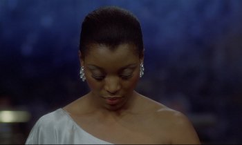 Movie still from “Diva” (1981), directed by Jean-Jacques Beineix – A woman in a white dress with her eyes closed; Close Up shot, Low angle