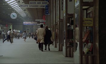 Movie still from “Diva” (1981), directed by Jean-Jacques Beineix – A couple of people walking down a sidewalk; Extreme Wide shot, High angle