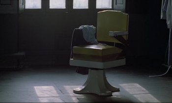 Movie still from “Diva” (1981), directed by Jean-Jacques Beineix – An old chair in the middle of a room; Wide shot, High angle