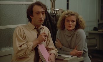 Movie still from “Diva” (1981), directed by Jean-Jacques Beineix – A man and a woman sitting next to each other at a table; Medium shot, Low angle