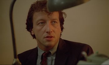 Movie still from “Diva” (1981), directed by Jean-Jacques Beineix – A person wearing a suit and tie; Close Up shot, Low angle