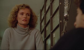Movie still from “Diva” (1981), directed by Jean-Jacques Beineix – A woman standing in front of a filing cabinet in a room; Close Up shot, Low angle