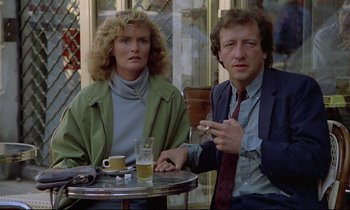 Movie still from “Diva” (1981), directed by Jean-Jacques Beineix – A man and a woman sitting at a table with a cigarette; Medium shot, Over the shoulder angle