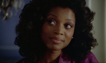 Movie still from “Diva” (1981), directed by Jean-Jacques Beineix – A person wearing a pink shirt; Close Up shot, Over the shoulder angle