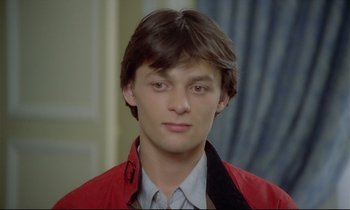 Movie still from “Diva” (1981), directed by Jean-Jacques Beineix – A young man wearing a red jacket looking at the camera; Close Up shot, High angle