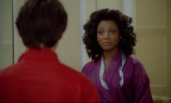 Movie still from “Diva” (1981), directed by Jean-Jacques Beineix – A woman looking into a mirror while standing next to a man; Close Up shot, Over the shoulder angle