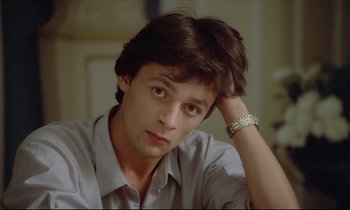 Movie still from “Diva” (1981), directed by Jean-Jacques Beineix – A young man with his head resting on his hand; Close Up shot, Low angle