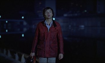 Movie still from “Diva” (1981), directed by Jean-Jacques Beineix – A man in a red jacket is holding a bag; Medium shot, Low angle