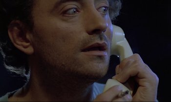 Movie still from “Diva” (1981), directed by Jean-Jacques Beineix – A person talking on a phone; Close Up shot, Low angle