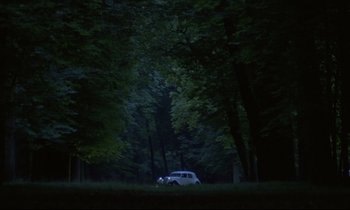 Movie still from “Diva” (1981), directed by Jean-Jacques Beineix – A car parked in the middle of a forest at night; Extreme Wide shot, Low angle