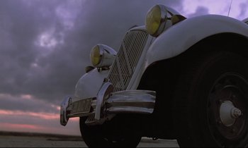 Movie still from “Diva” (1981), directed by Jean-Jacques Beineix – The front end of an antique car; Wide shot, Low angle