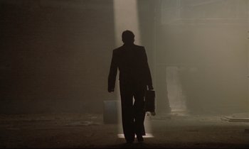 Movie still from “Diva” (1981), directed by Jean-Jacques Beineix – A man in a suit walking in the dark; Wide shot, Low angle