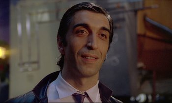 Movie still from “Diva” (1981), directed by Jean-Jacques Beineix – A person wearing a suit and tie; Close Up shot, Low angle
