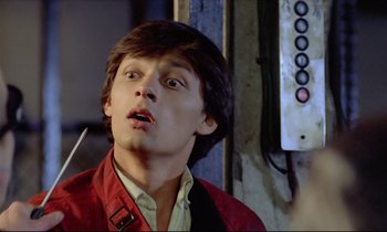 Movie still from “Diva” (1981), directed by Jean-Jacques Beineix – A young man in a red jacket is looking at the camera; Close Up shot, Low angle