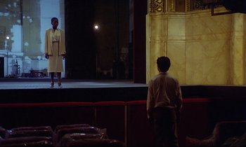 Movie still from “Diva” (1981), directed by Jean-Jacques Beineix – A man and a woman on a stage in front of an audience; Extreme Wide shot, Low angle