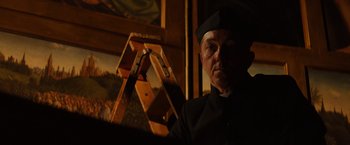 Movie still from “The Monuments Men” (2014), directed by George Clooney – A man wearing a black hat and a uniform; Medium shot, Low angle