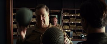 Movie still from “The Monuments Men” (2014), directed by George Clooney – A man in a military uniform holding an army helmet; Close Up shot, Over the shoulder angle
