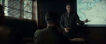 Movie still from “The Monuments Men” (2014), directed by George Clooney – A man standing in front of a mirror in front of another man; Medium shot, Over the shoulder angle