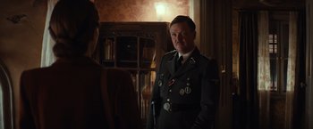 Movie still from “The Monuments Men” (2014), directed by George Clooney – A man in a military uniform standing next to a woman; Medium shot, Over the shoulder angle