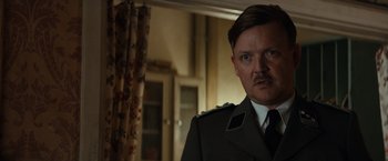 Movie still from “The Monuments Men” (2014), directed by George Clooney – A person wearing a uniform; Close Up shot, Over the shoulder angle