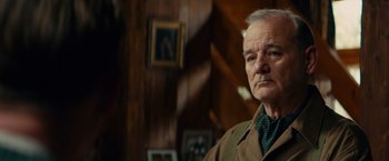 Movie still from “The Monuments Men” (2014), directed by George Clooney – An older man standing in front of a wooden wall; Close Up shot, Over the shoulder angle