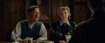 Movie still from “The Monuments Men” (2014), directed by George Clooney – A man and a woman sitting at a dinner table; Medium shot, Low angle