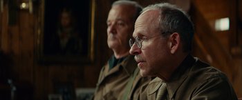 Movie still from “The Monuments Men” (2014), directed by George Clooney – Two older men wearing glasses looking into the distance; Close Up shot, Low angle