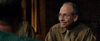 Movie still from “The Monuments Men” (2014), directed by George Clooney – An older man wearing glasses and a tie; Close Up shot, Over the shoulder angle