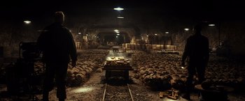Movie still from “The Monuments Men” (2014), directed by George Clooney – A train track in the middle of an underground tunnel; Extreme Wide shot, High angle