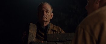 Movie still from “The Monuments Men” (2014), directed by George Clooney – An older man wearing a brown jacket and a neck tie; Close Up shot, Over the shoulder angle