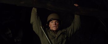 Movie still from “The Monuments Men” (2014), directed by George Clooney – A man in a military uniform holding a wooden board; Medium shot, Low angle
