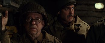 Movie still from “The Monuments Men” (2014), directed by George Clooney – Two men in military fatigues and helmets; Close Up shot, Low angle