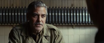 Movie still from “The Monuments Men” (2014), directed by George Clooney – An older man with a mustache wearing a tan jacket; Close Up shot, Over the shoulder angle