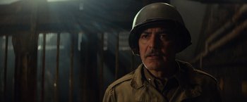 Movie still from “The Monuments Men” (2014), directed by George Clooney – An older man wearing a military uniform and a helmet; Close Up shot, Over the shoulder angle