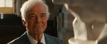 Movie still from “The Monuments Men” (2014), directed by George Clooney – An older man in a suit and tie looking at the camera; Close Up shot, Over the shoulder angle