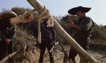 Movie still from “Django” (1966), directed by Sergio Corbucci – Two men in cowboy garb are holding a rope; Medium shot, Low angle