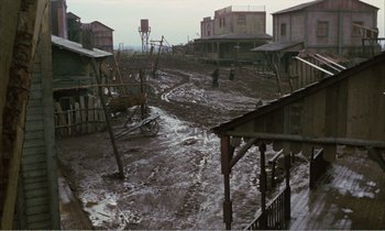 Movie still from “Django” (1966), directed by Sergio Corbucci – An old town is flooded with mud and debris; Extreme Wide shot, High angle