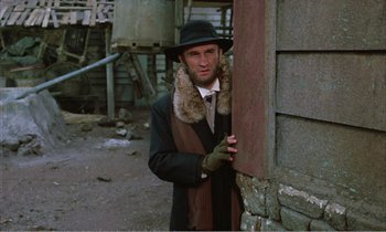 Movie still from “Django” (1966), directed by Sergio Corbucci – A man wearing a hat and a fur coat; Medium shot, Low angle