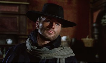 Movie still from “Django” (1966), directed by Sergio Corbucci – A man wearing a black hat and a scarf; Close Up shot, Low angle