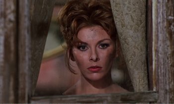 Movie still from “Django” (1966), directed by Sergio Corbucci – A beautiful woman with brown hair and green eyes looking at the camera; Close Up shot, Low angle